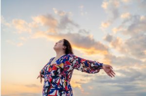 young asian woman at sunrise dealing with grief and overcoming a big loss