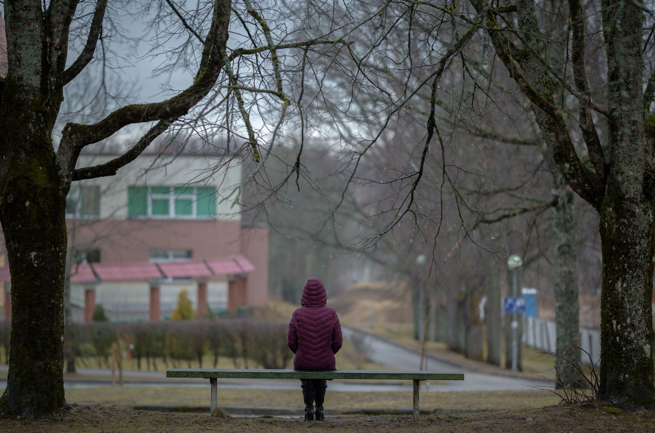 woman sitting on park bench experiencing anger and depression