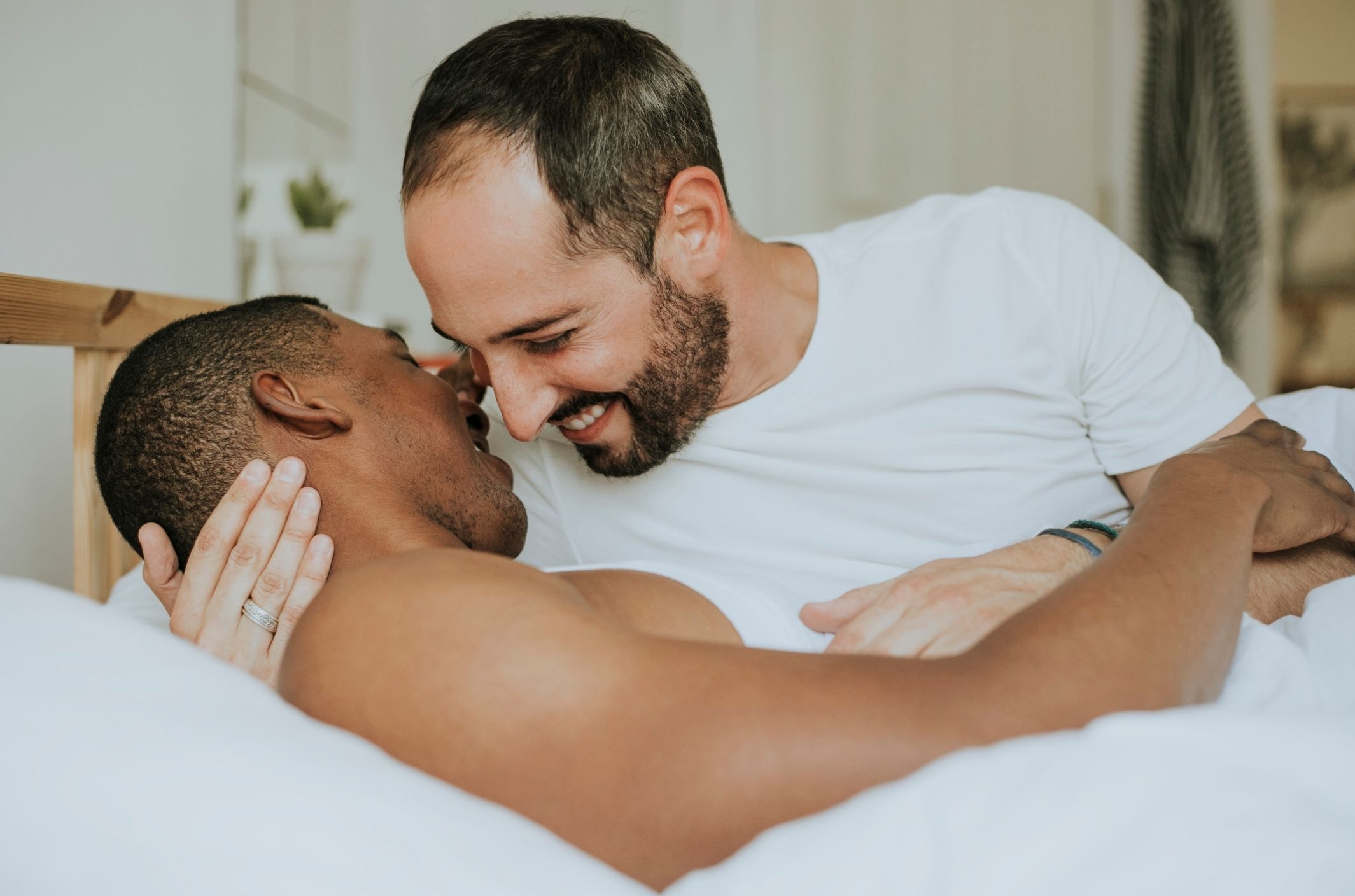 Premature ejaculation: symptoms, causes, & treatment men in bed smiling after treatment for premature ejaculation symptoms