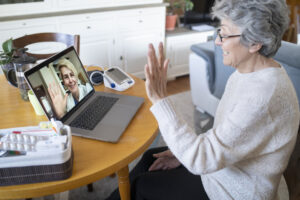 Woman at home on a virtual doctor visit, discussing the importance of consulting with a healthcare provider before starting Ozempic®, including reviewing medical history, determining the right dosage, and planning follow-up appointments for the best results.
