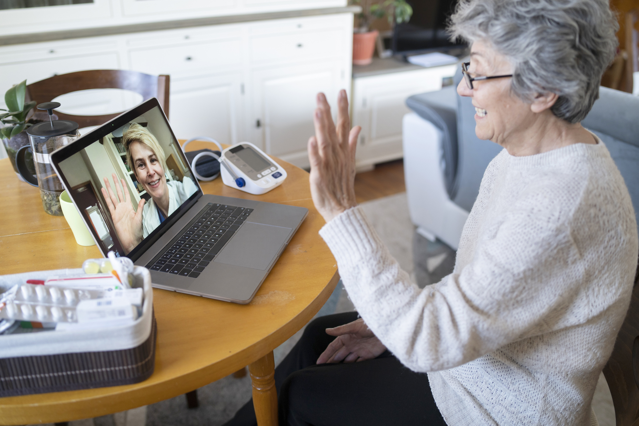 Woman at home on a virtual doctor visit, discussing the importance of consulting with a healthcare provider before starting Ozempic®, including reviewing medical history, determining the right dosage, and planning follow-up appointments for the best results.